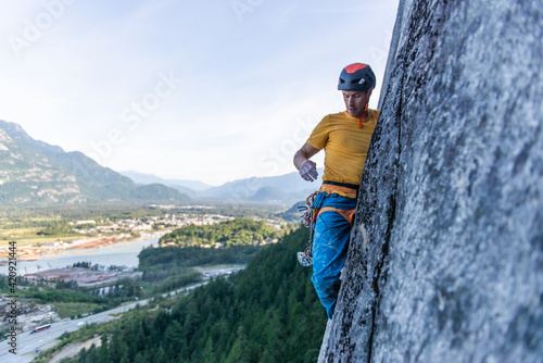 A climber traditional climbing on granite, Tantalus Wall, Squamish