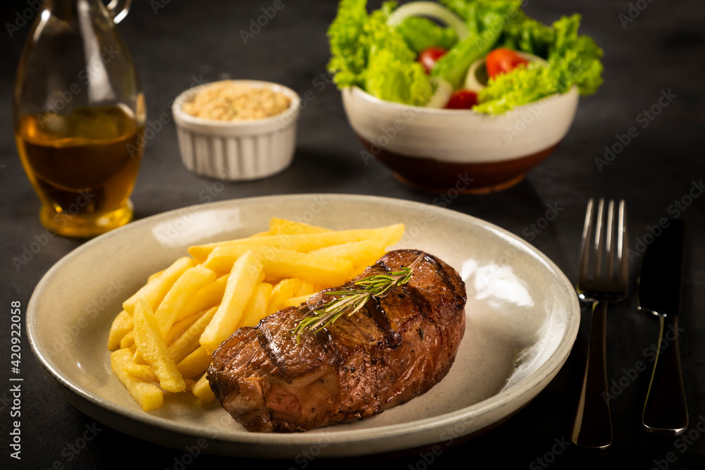 Grilled steak with french fries, brazilian farofa and salad. Grilled steak with french fries, brazilian farofa and salad.