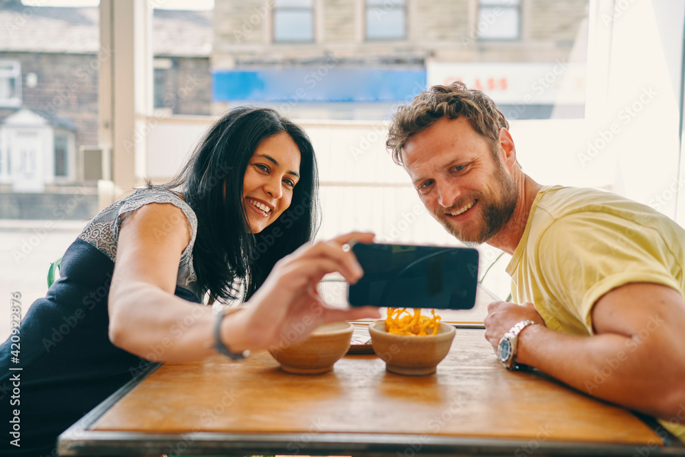 Couple taking selfie in restaurant Couple taking selfie in restaurant