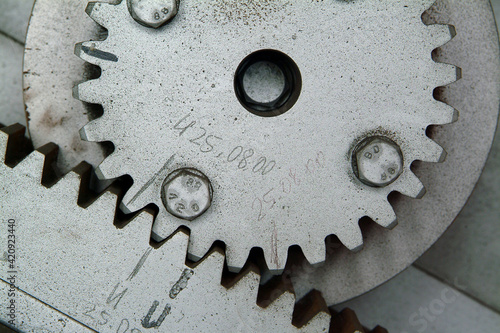 Close up of old wooden cogwheel in abandoned factory. photo