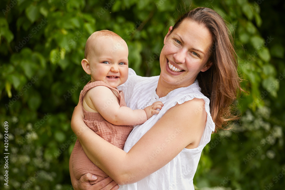 Portrait of mother and baby daughter smiling at camera. Portrait of mother and baby daughter smiling at camera.