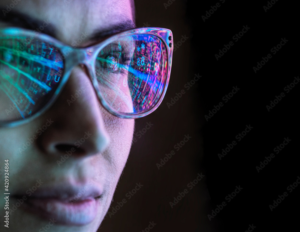 Electronic circuit board on computer monitor reflecting in glasses of a female engineer. Electronic circuit board on computer monitor reflecting in glasses of a female engineer.