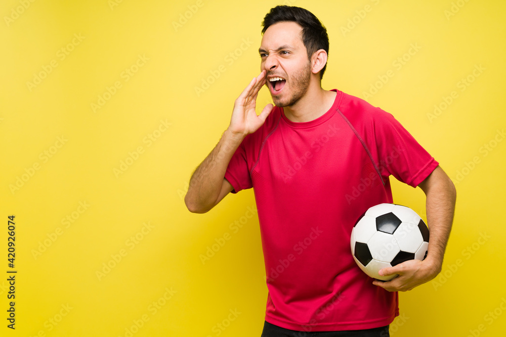 Excited latin man in his 30s enjoying a soccer game Excited latin man in his 30s enjoying a soccer game