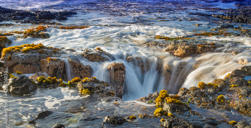 Ocean waves refilling Pele’s Well lava tube near Wawaloli Beach on the Big Island of Hawaii