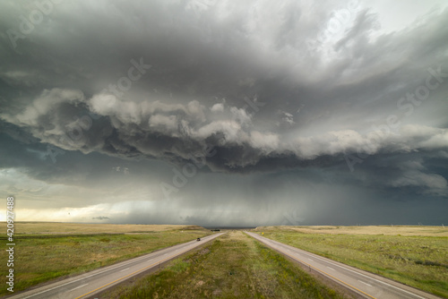 Incredible supercell spinning across Wyoming, sky full of dark storm clouds photo