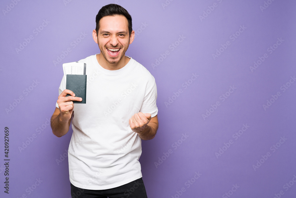 Happy latin man celebrating going on a vacation Happy latin man celebrating going on a vacation