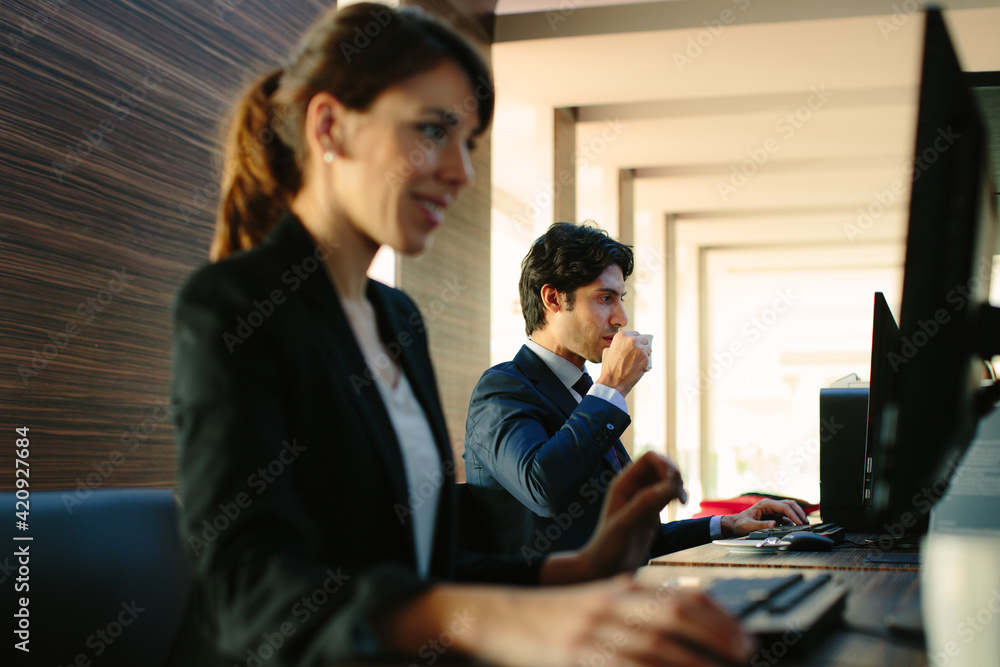 Businessman and businesswoman working in business centre in hotel Businessman and businesswoman working in business centre in hotel