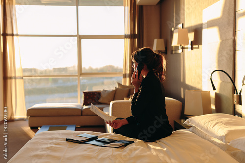 Businesswoman ordering room service in hotel photo
