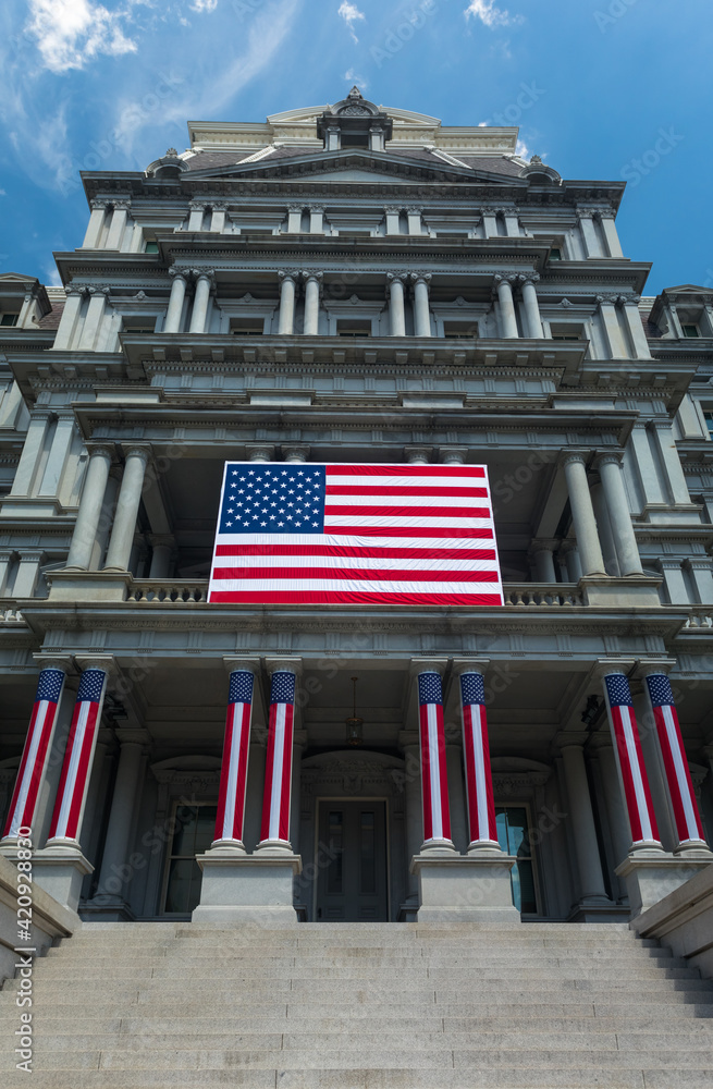Washington, DC, USA - 29 June 2020: Entrance of the Eisenhower Executive Office Building decorated with US Flags in Preparation of Independence Day