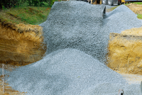 Close up of excavator bucket scooping gravel from in the building foundation photo