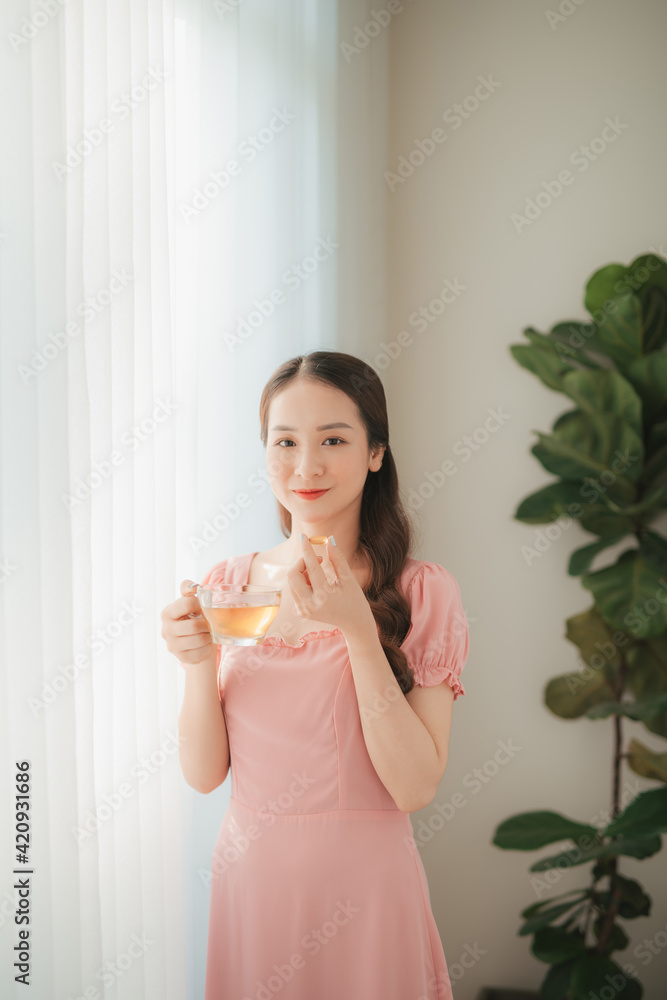 beautiful asian women healthy diet eating vitamin pill with water beautiful asian women healthy diet eating vitamin pill with water