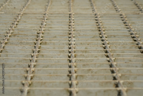 Metal grating walkway with low angle view.
