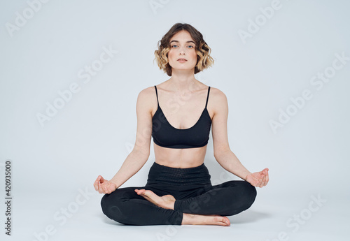 woman go in for sports on a light background yoga meditation asana