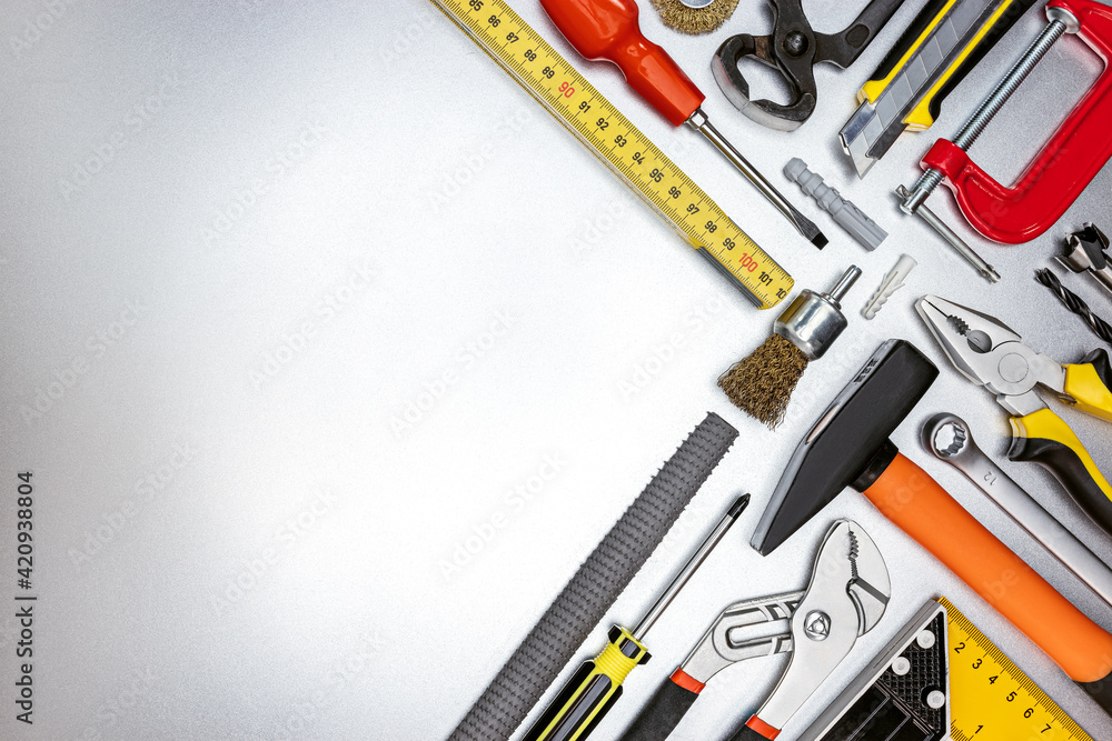 Fototapeta premium set of different professional hand tools for construction and renovation on metal desk. top view