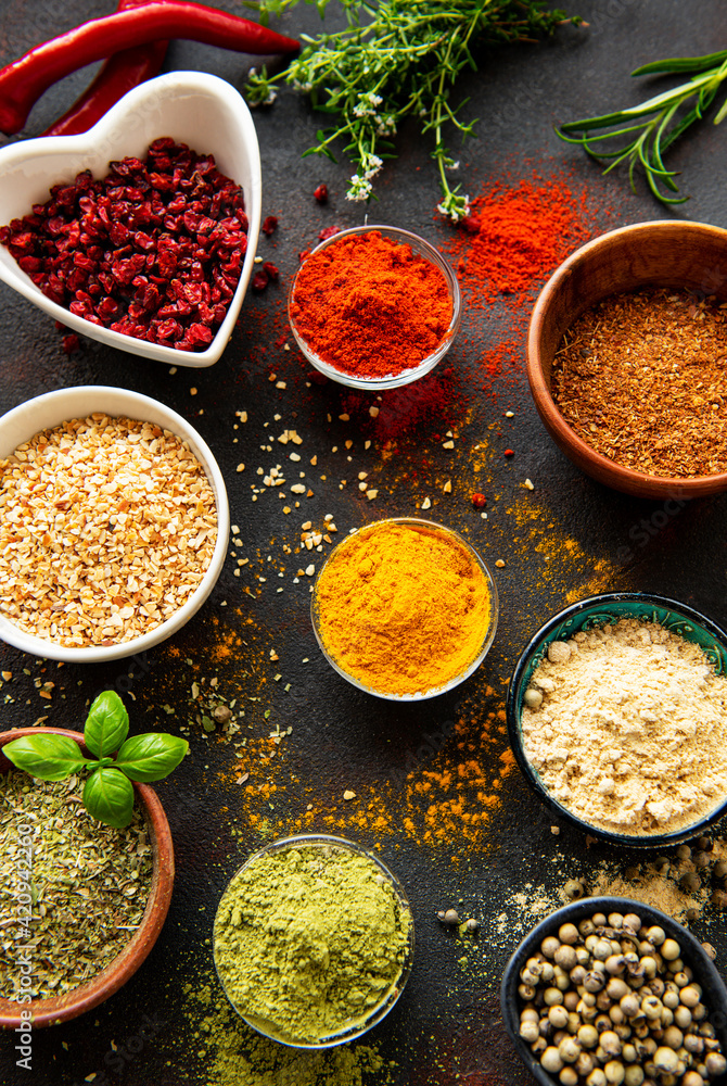 Colorful and aromatic herbs and spices on a dark background Colorful and aromatic herbs and spices on a dark background