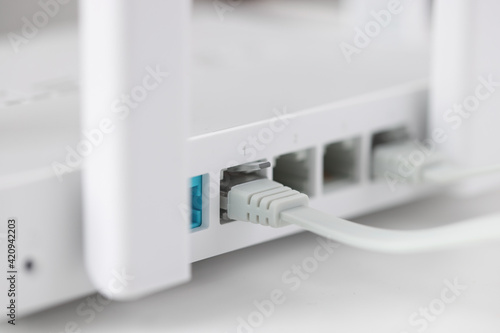 Obraz na płótnie Network cable is plugged into socket of access point closeup