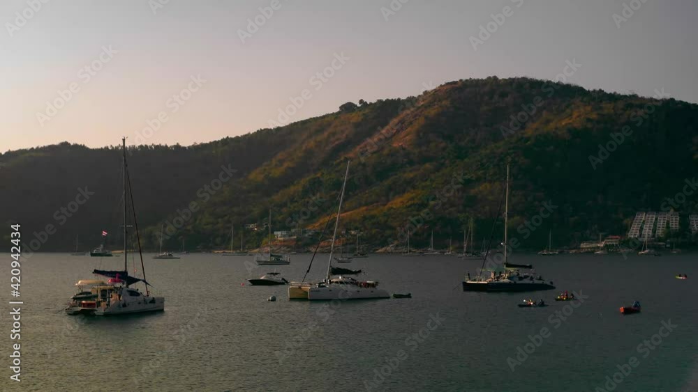 Thailand. Ya Nui Beach. Beautiful sunset on the beach. Phuket. Naiharn. Naiharn beach view. Yachts and boats at anchorage. 4K Thailand. Ya Nui Beach. Beautiful sunset on the beach. Phuket. Naiharn. Naiharn beach view. Yachts and boats at anchorage. 4K