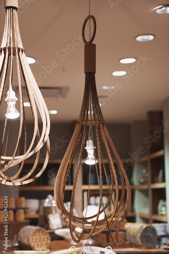 Illuminated hand made hanging wooden lamps. Bohemian, boho style, neutral  brown earthy tones photo © Ido