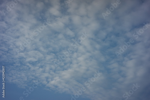 clear blue sky in the morning. The bright clouds are white and have a beautiful pattern