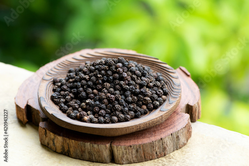 Dried black pepper on nature background. photo