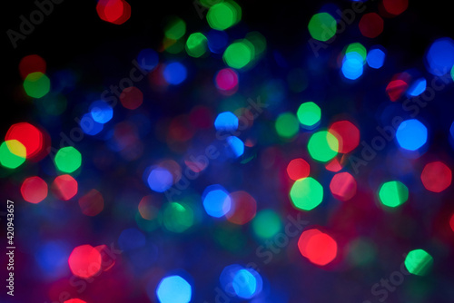 Blurred background, multicolored Christmas, New Year garland out of focus.
