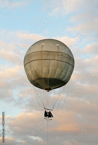 Two tourists fly in a sightseeing hot air balloon.