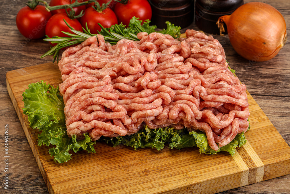 Raw pork minced meat over board Raw pork minced meat over board