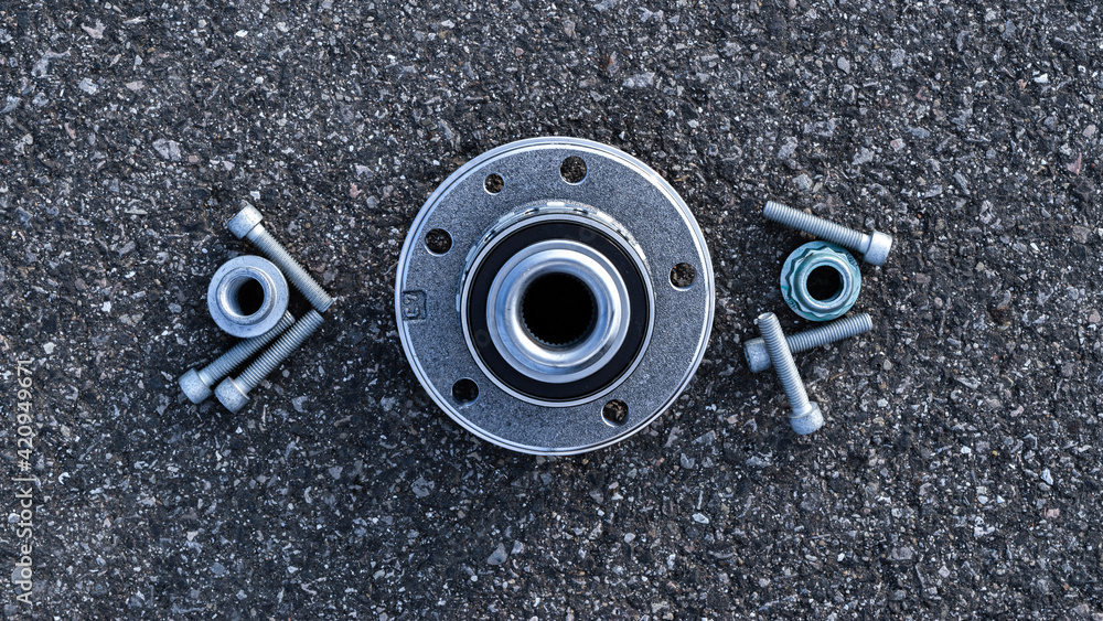 Sapre parts. Auto motor mechanic spare or automotive piece on dark road asphalt background. Set of new metal car part. Surface grunge rough of asphalt. Sapre parts. Auto motor mechanic spare or automotive piece on dark road asphalt background. Set of new metal car part. Surface grunge rough of asphalt.