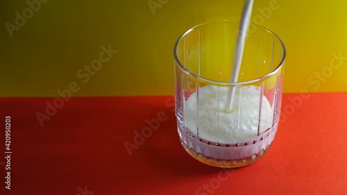 A beautiful glass jug into which milk is poured.