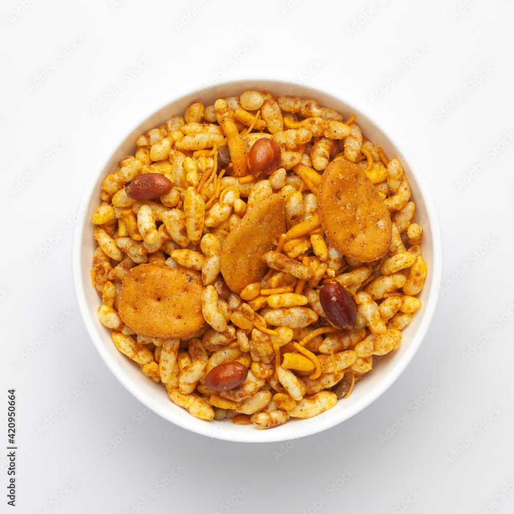 Close up of very spicy sweet Fatafat Bhel mixture Indian namkeen (snacks) on a ceramic white bowl. Top view Close up of very spicy sweet Fatafat Bhel mixture Indian namkeen (snacks) on a ceramic white bowl. Top view