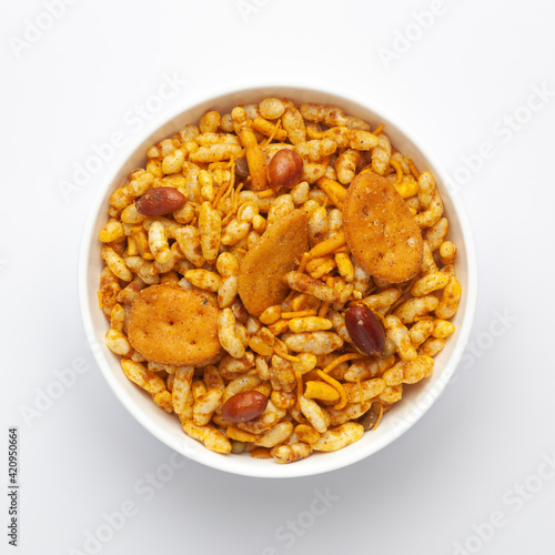Close up of very spicy sweet Fatafat Bhel mixture Indian namkeen (snacks) on a ceramic white bowl. Top view
