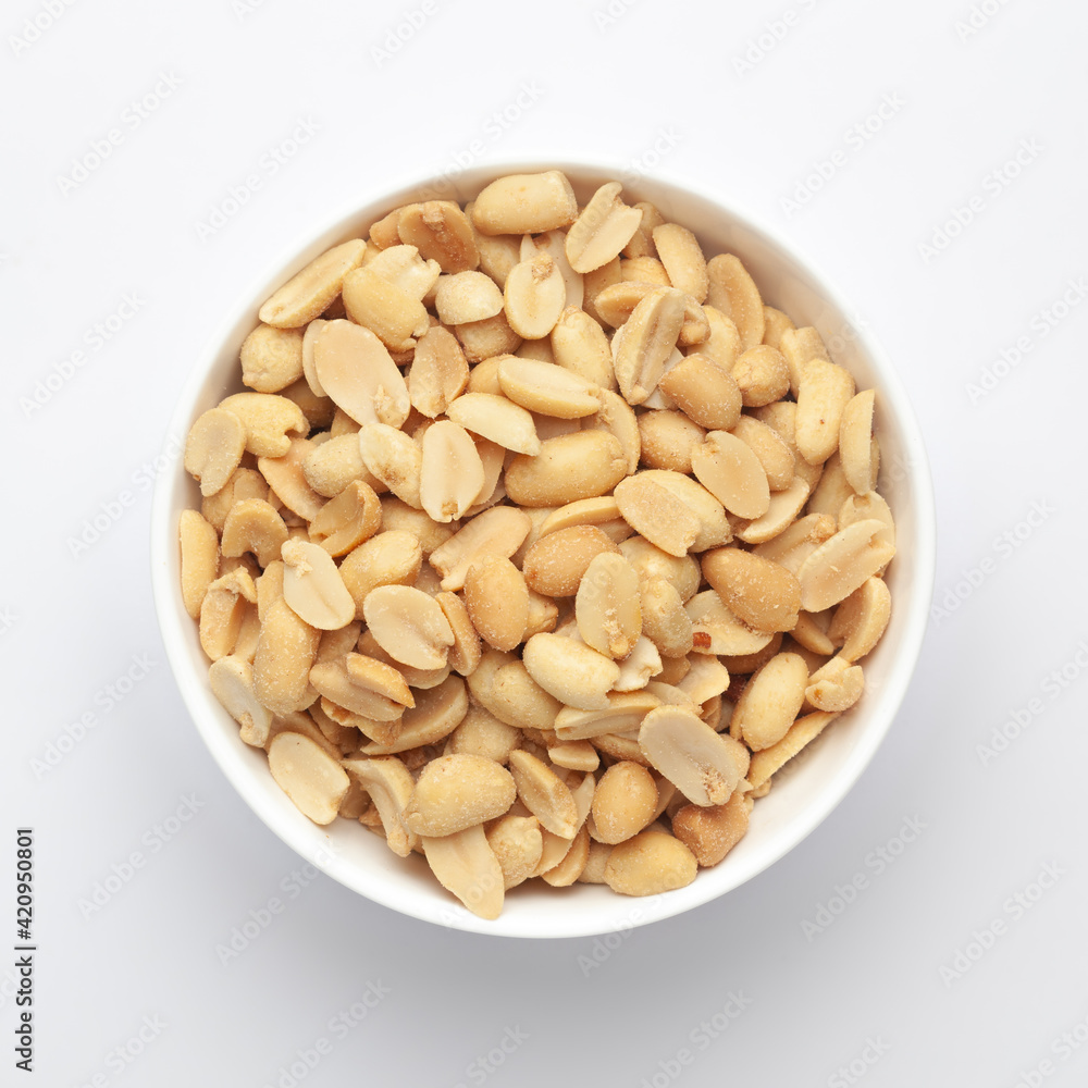 Close up of Salted Peanuts Indian namkeen (snacks) on a ceramic white bowl. Top view
Close up of Salted Peanuts Indian namkeen (snacks) on a ceramic white bowl. Top view