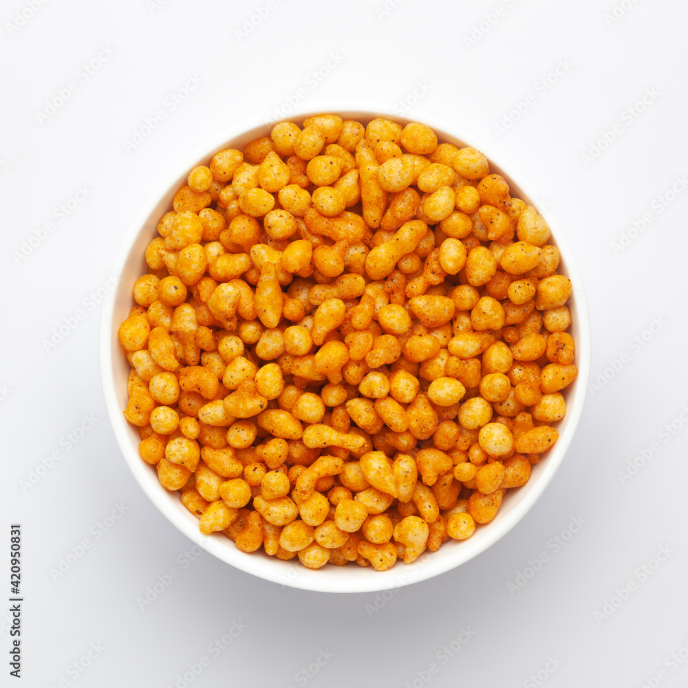 Close up of crunchy masala boondi Indian namkeen (snacks) on a ceramic white bowl. Top view Close up of crunchy masala boondi Indian namkeen (snacks) on a ceramic white bowl. Top view