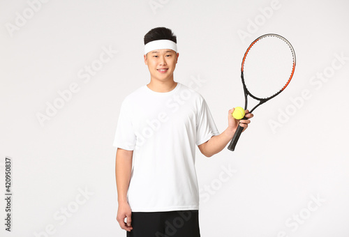 Asian tennis player on white background © Pixel-Shot