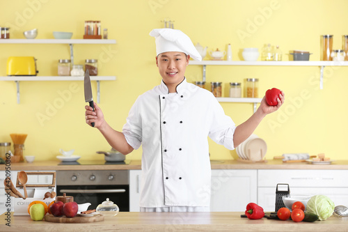 Male Asian chef in kitchen