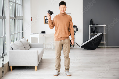 Young Asian photographer in...