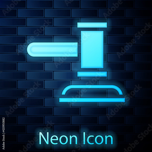 Glowing neon Judge gavel icon isolated on brick wall background. Gavel for adjudication of sentences and bills, court, justice. Auction hammer. Vector