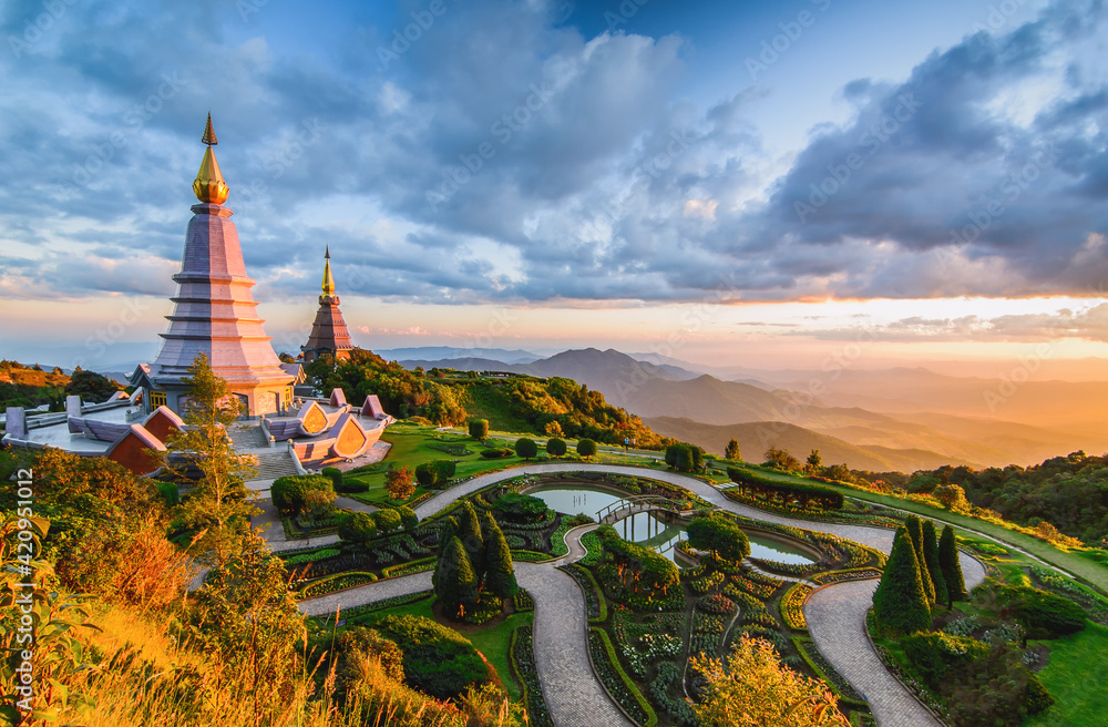Landscape of two pagoda in Doi Inthanon Mountain with evening orange light splashed at the pagoda in sunset, Chaingmai, Thailand