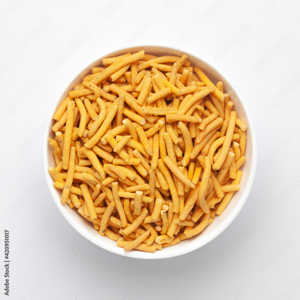 Close up of Marwadi Bhujiya Indian namkeen (snacks) on a ceramic white bowl. Top view Close up of Marwadi Bhujiya Indian namkeen (snacks) on a ceramic white bowl. Top view