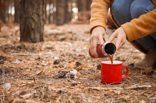 Woman pouring hot coffee fr...