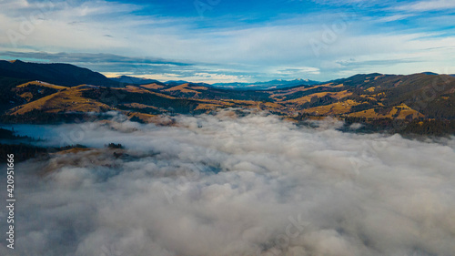 mountains tops high above clouds fog