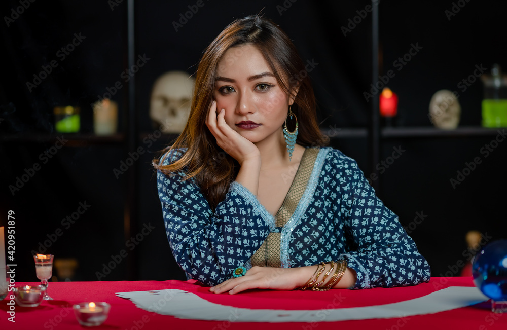 Asian fortune teller reading cards with closed eyes Asian fortune teller reading cards with closed eyes