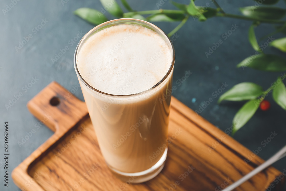 Glass of tasty latte on dark background Glass of tasty latte on dark background