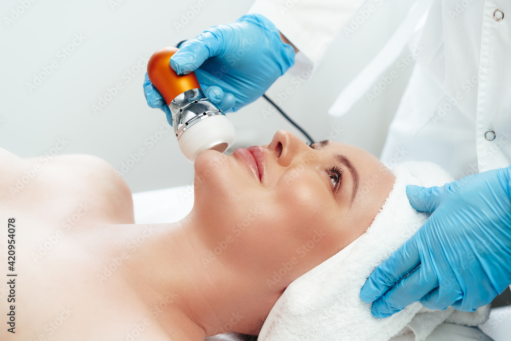 Beautiful woman getting facial skincare treatment in a cosmetic beauty clinic Beautiful woman getting facial skincare treatment in a cosmetic beauty clinic