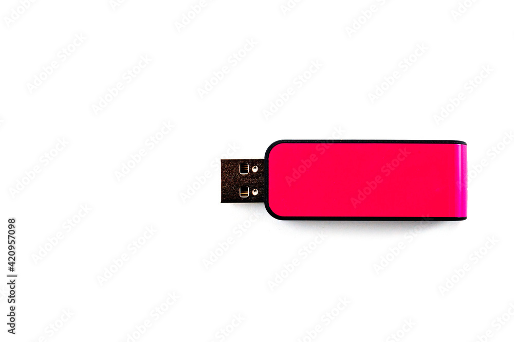 A pink USB flash drive with a plastic case, shot against a white background. A pink USB flash drive with a plastic case, shot against a white background.