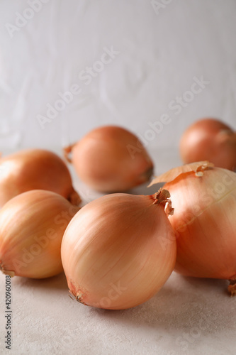 Fresh ripe onion on white textured background