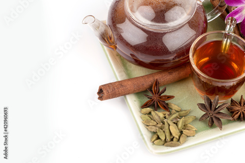 Green cardamom ,star anise ,cinnamon bark and tea isolated on white background.