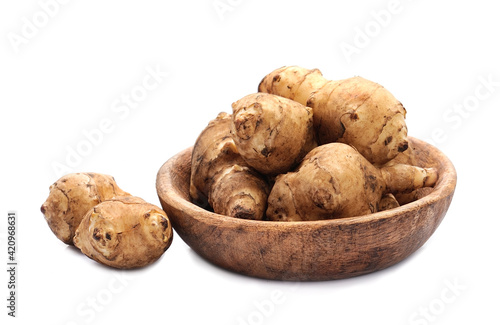 Jerusalem artichoke root on wooden plate.