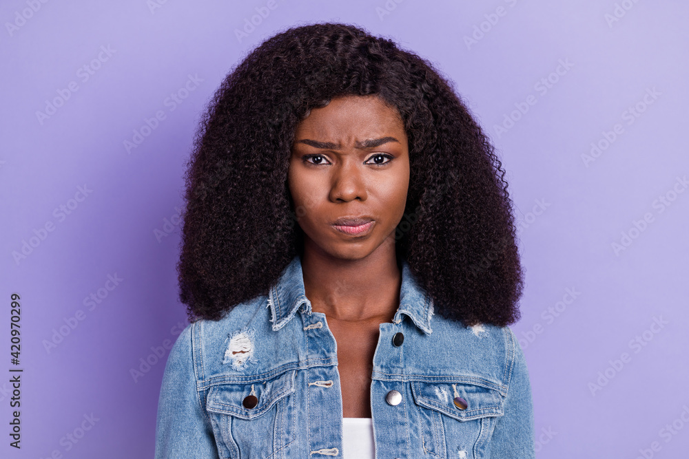 Photo of young unhappy upset angry irritated afro woman having problem trouble isolated on purple color background Photo of young unhappy upset angry irritated afro woman having problem trouble isolated on purple color background