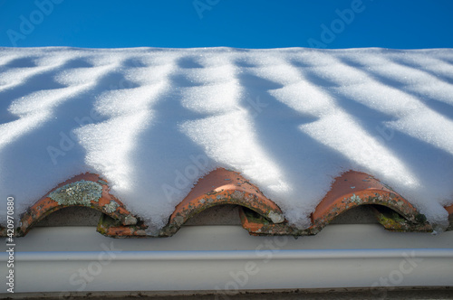 Snow covered mediterranean roof tiles